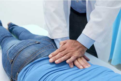 Woman on table getting chiropractic adjustments in Cape Coral