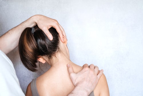Sunrise neck injury treatment, woman having chiropractic neck adjustment