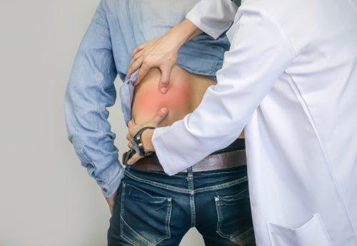 Chiropractor examines man for Boca Raton back injury treatment