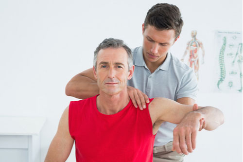 Mature man with shoulder pain getting Fort Lauderdale bursitis treatment